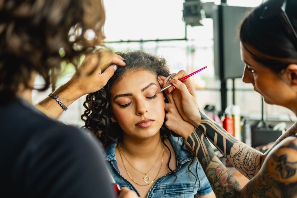 Talented makeup artist applying eyeshadow in a vibrant Toronto studio setting.