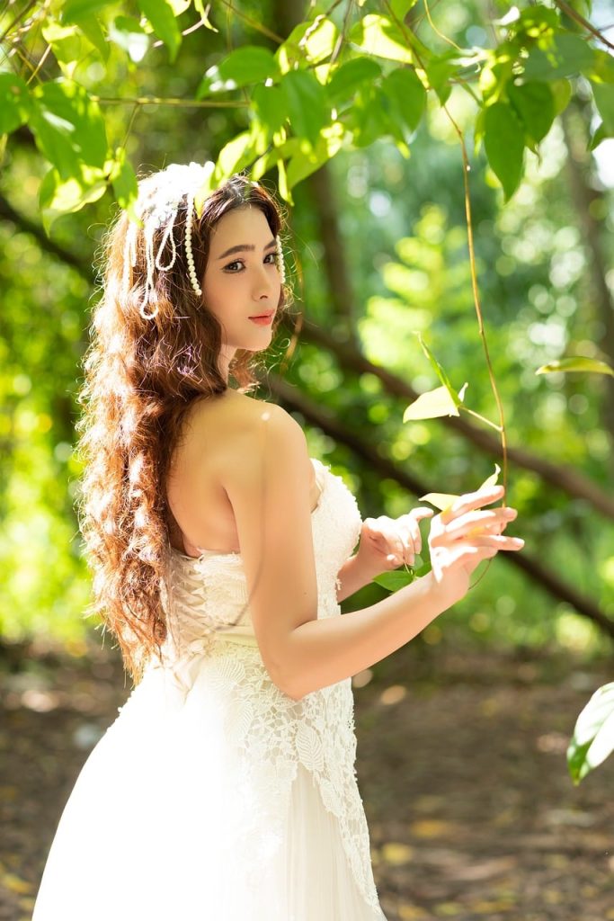 woman, portrait, vietnamese, white, landscape, forest, nature, green leaves, curly hair, dress, wedding dress, fashion, trend, outdoors, edge, daylight, romantic, style, blinds, hem